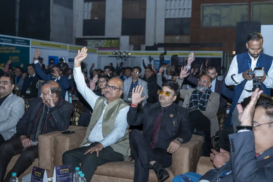 Audience members raising their hands during an interactive session at the MSME awards evening