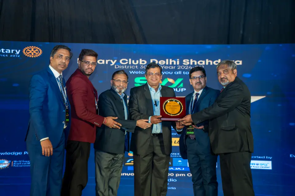 Award plaque being presented on stage at the Rotary Club Delhi Shahdara MSME awards evening