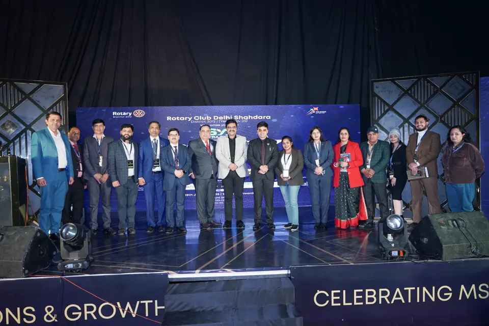 Award recipients lined up on stage in front of the Celebrating MSME banner