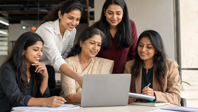 A group of Indian women entrepreneurs working together around a laptop in an office